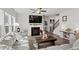 Cozy living room featuring a fireplace, ceiling fan, and lots of natural light at 242 Crestbrook Ln, Dallas, GA 30157