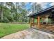 Expansive backyard featuring a covered patio with a fireplace, a well-maintained lawn and privacy fence at 3356 Thornewood Dr, Atlanta, GA 30340