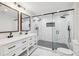 Modern bathroom with double vanity and glass-enclosed shower with black hardware at 3356 Thornewood Dr, Atlanta, GA 30340