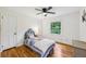 Cozy bedroom with hardwood floors, ceiling fan, and a large window at 3356 Thornewood Dr, Atlanta, GA 30340