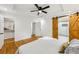 Bedroom with wood floors, ceiling fan, closet, and barn-style sliding door to the bathroom at 3356 Thornewood Dr, Atlanta, GA 30340