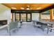 Cozy covered patio with fireplace, ceiling fan, wood ceiling and furniture perfect for relaxing with guests at 3356 Thornewood Dr, Atlanta, GA 30340