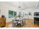 Dining area with a modern chandelier, and adjacent to kitchen with white cabinetry at 3356 Thornewood Dr, Atlanta, GA 30340