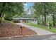 Quaint renovated home with white painted brick, a teal front door, and long driveway at 3356 Thornewood Dr, Atlanta, GA 30340