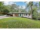 Charming renovated home with white painted brick and a teal front door, nestled on a lush, tree-filled lot at 3356 Thornewood Dr, Atlanta, GA 30340