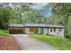 Charming renovated home with white painted brick, a teal front door, and long driveway at 3356 Thornewood Dr, Atlanta, GA 30340
