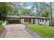 Well maintained home with white painted brick, a teal front door, and convenient covered parking at 3356 Thornewood Dr, Atlanta, GA 30340