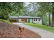 Quaint renovated home with white painted brick, a teal front door, and long driveway at 3356 Thornewood Dr, Atlanta, GA 30340