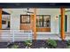 Inviting covered front porch with teal door, modern lighting, and wood accents at 3356 Thornewood Dr, Atlanta, GA 30340