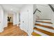 Hallway featuring beautiful wood floors and stairwell to the upper level at 3356 Thornewood Dr, Atlanta, GA 30340