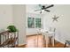 Bright home office featuring natural light, ceiling fan, hardwood floors, and shelving at 3356 Thornewood Dr, Atlanta, GA 30340