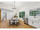 Bright open-concept kitchen & dining area, boasting white cabinets, modern finishes and stainless appliances at 3356 Thornewood Dr, Atlanta, GA 30340