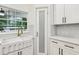Bright kitchen with double farmhouse sink, brass faucet, white cabinets and subway tile backsplash at 3356 Thornewood Dr, Atlanta, GA 30340