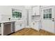 Well-lit kitchen featuring stainless steel appliances, farm sink, and white shaker cabinetry at 3356 Thornewood Dr, Atlanta, GA 30340