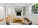 View of a living room showing hardwood floors, a decorative fireplace, and a large window at 3356 Thornewood Dr, Atlanta, GA 30340