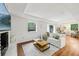 Bright living room with hardwood floors, a decorative fireplace, and a large window overlooking the yard at 3356 Thornewood Dr, Atlanta, GA 30340