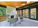 Covered porch with skylights, fireplace, and comfortable seating overlooking a garden at 3356 Thornewood Dr, Atlanta, GA 30340