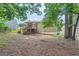 Backyard showcasing a two-story home with a wooden deck, mature trees, and lush greenery at 4470 Hopkins Lake Nw Dr, Duluth, GA 30096