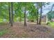 Backyard featuring a two-story home with a wooden deck and mature trees at 4470 Hopkins Lake Nw Dr, Duluth, GA 30096