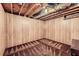 Unfinished basement featuring wooden walls, carpeted floor, and exposed ceiling beams at 4470 Hopkins Lake Nw Dr, Duluth, GA 30096