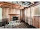 Basement with wooden walls, classic fireplace with brick hearth, and natural light window at 4470 Hopkins Lake Nw Dr, Duluth, GA 30096
