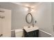 Cozy bathroom featuring a classic oval mirror, white tiled shower and gray painted walls at 4470 Hopkins Lake Nw Dr, Duluth, GA 30096