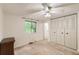 Cozy bedroom with carpeted floors, built-in closet, and a window for natural light at 4470 Hopkins Lake Nw Dr, Duluth, GA 30096