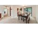 Open dining room featuring a dark wood table, 6 upholstered chairs, and sliding glass doors at 4470 Hopkins Lake Nw Dr, Duluth, GA 30096