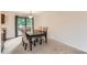 Open dining room featuring a dark wood table, 6 upholstered chairs, and sliding glass doors at 4470 Hopkins Lake Nw Dr, Duluth, GA 30096