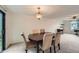 Open dining room with neutral carpet, dark wood table, seating for six, and sliding glass doors at 4470 Hopkins Lake Nw Dr, Duluth, GA 30096