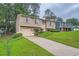 Inviting two-story home boasts a well-manicured front yard and attached one car garage at 4470 Hopkins Lake Nw Dr, Duluth, GA 30096
