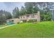 A two-story home has a well-manicured lawn and a long driveway at 4470 Hopkins Lake Nw Dr, Duluth, GA 30096