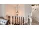View of an upstairs landing with chandelier and brown wooden railing at 4470 Hopkins Lake Nw Dr, Duluth, GA 30096