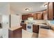 Traditional kitchen with wooden cabinets, white appliances, and laminate countertops at 4470 Hopkins Lake Nw Dr, Duluth, GA 30096