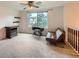 Cozy upstairs loft space with neutral carpet, window view, and vintage sewing machine at 4470 Hopkins Lake Nw Dr, Duluth, GA 30096