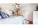 Bright bedroom with a ceiling fan, wood floors and a stylish bed with decorative pillows at 773 N Superior Ave, Decatur, GA 30033