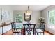 Dining room features glass table, ornate chairs, and abundant natural light at 773 N Superior Ave, Decatur, GA 30033