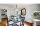 Dining room with glass table, ornate chairs, hardwood floors, and view to kitchen at 773 N Superior Ave, Decatur, GA 30033