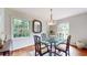 Dining room with glass table, ornate chairs, hardwood floors, and view to outside at 773 N Superior Ave, Decatur, GA 30033
