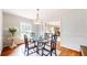 Dining room with glass table, ornate chairs, hardwood floors, and elegant decor at 773 N Superior Ave, Decatur, GA 30033