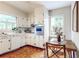 Bright kitchen with white cabinets, stainless steel oven, and dining table at 773 N Superior Ave, Decatur, GA 30033