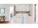 Laundry room featuring a washer and dryer with overhead cabinets for storage at 773 N Superior Ave, Decatur, GA 30033