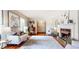 Bright and airy living room with fireplace, elegant decor, and hardwood floors at 773 N Superior Ave, Decatur, GA 30033