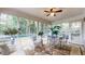 Bright sunroom with many windows, ceiling fan, tile floor, and glass table at 773 N Superior Ave, Decatur, GA 30033