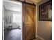 Bathroom features a barn door, glass shower, black floors, and a window at 1164 Baylor Nw St, Atlanta, GA 30318