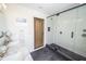 Bathroom featuring double vanity, marble countertop, and a glass shower with black trim at 1164 Baylor Nw St, Atlanta, GA 30318