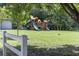A backyard playground area, surrounded by lush greenery, offers ample space for children to play at 1164 Baylor Nw St, Atlanta, GA 30318