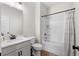 A clean and simple bathroom features a single sink vanity, a toilet, and a shower-tub combo at 153 Witter Way, Woodstock, GA 30188