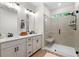 Modern bathroom featuring double sinks, quartz countertops, a glass-enclosed shower with a built-in bench, and hardwood floors at 153 Witter Way, Woodstock, GA 30188