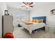 This bedroom features a queen bed, bedside tables with drawers, and a window letting in ample natural light at 153 Witter Way, Woodstock, GA 30188